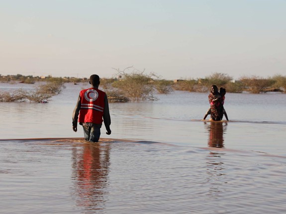 Människor som vadar efter översvämning