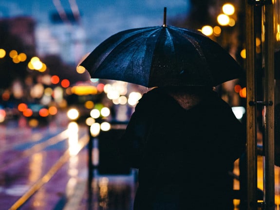 Regnig stadsmiljö, person med paraply