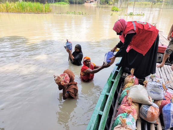 Mat delas ut vid översvämning i Bangladesh.
