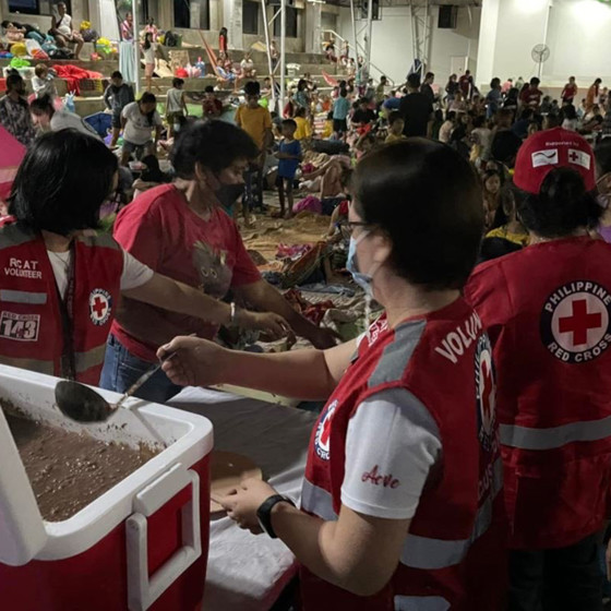 Röda korsvolontärer delar ut mat