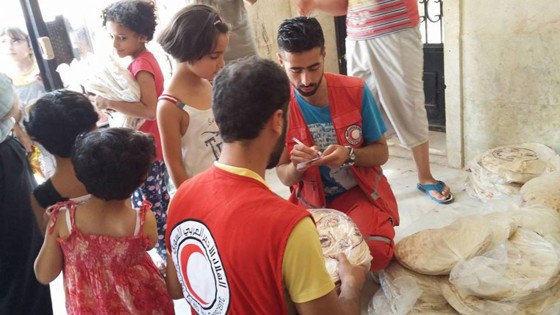 Brödpaket delas ut i krigets Aleppo