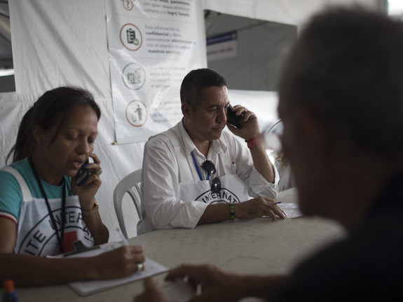 Man from International Red Cross and Red Crescent talking on phone.