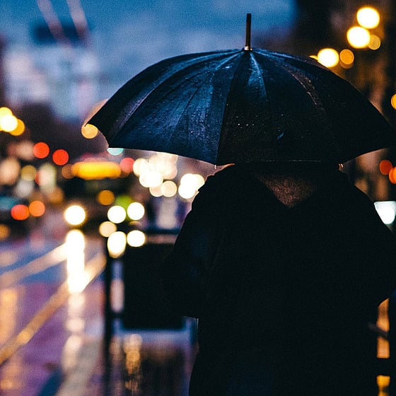 Regnig stadsmiljö, person med paraply