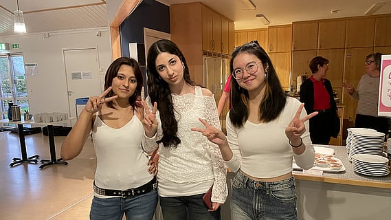 Tre tjejer från Voicepop för Världens Barn framför musikcaféet