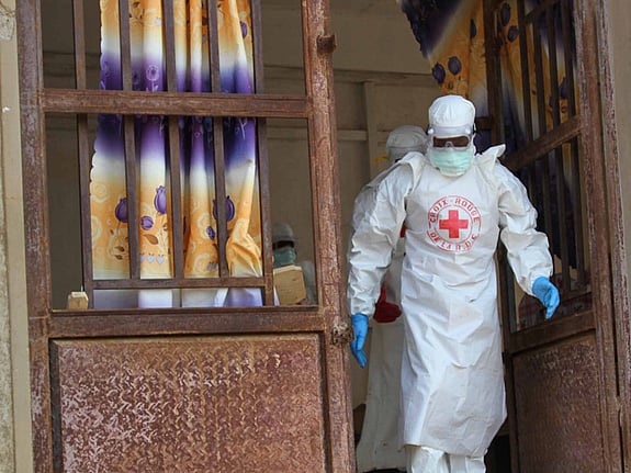 Ebolautbrott där vitklädd volontär hjälper.