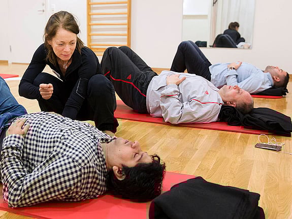 Man ligger på matta och talar med kvinna.