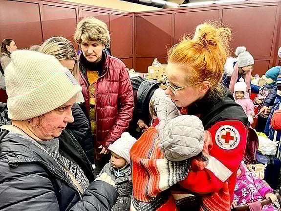 Röda Korset volontär hjälper flyktingar från Ukraina.
