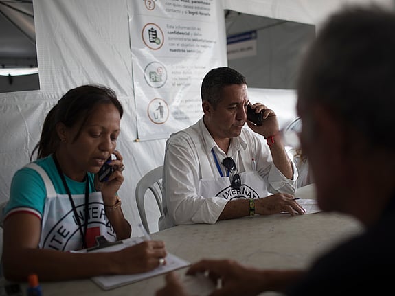 Man from International Red Cross and Red Crescent talking on phone.