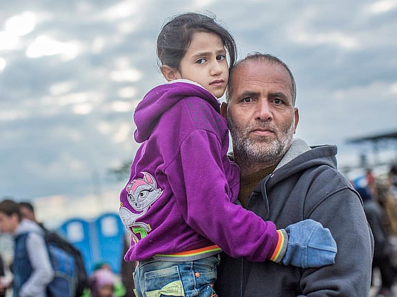 Man håller i liten flicka