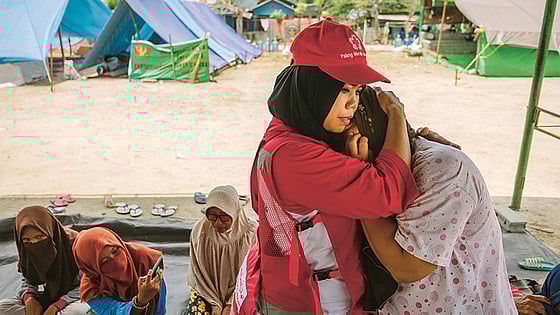 Volontär tröstar kvinna i kris.