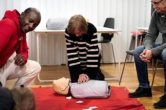 En kvinna tränar hjärt- lungräddning på en docka